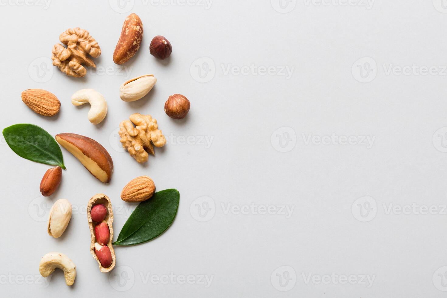 Composition of nuts mix hazelnuts, cashews, almonds on table background. healthy eating concepts and food background photo