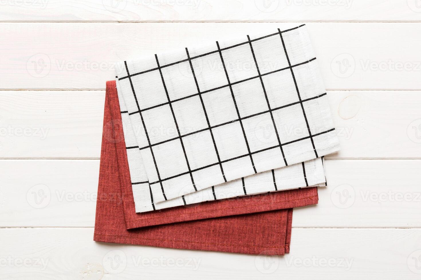 white empty kitchen napkin isolated on table background. Folded cloth for mockup photo