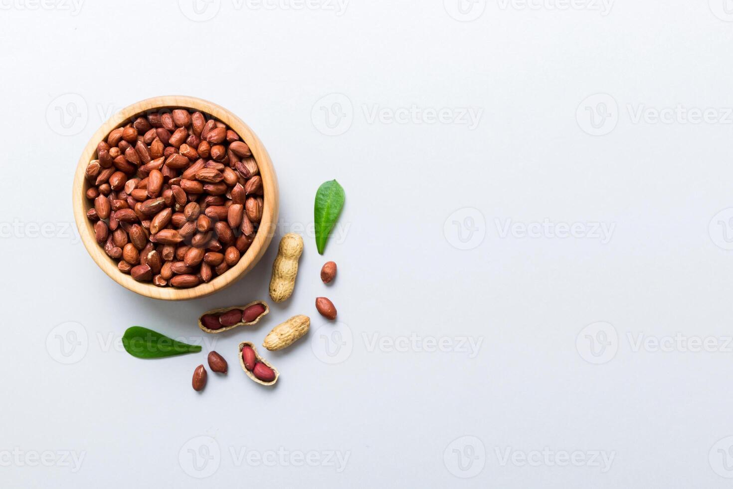 healthy peanuts in bowl on colored table background. Top view Healthy eating bertholletia concept. photo