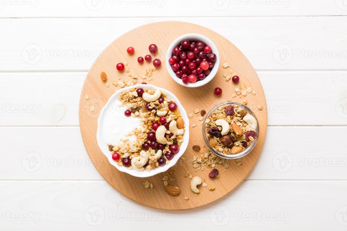 Healthy breakfast food with granola, fruits and nuts. Dessert parfait fruits photo