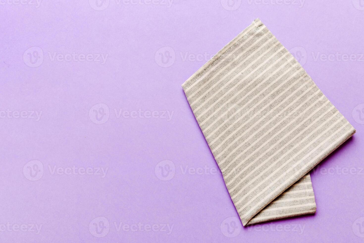 top view with gray kitchen napkin isolated on table background. Folded cloth mockup with copy space, photo