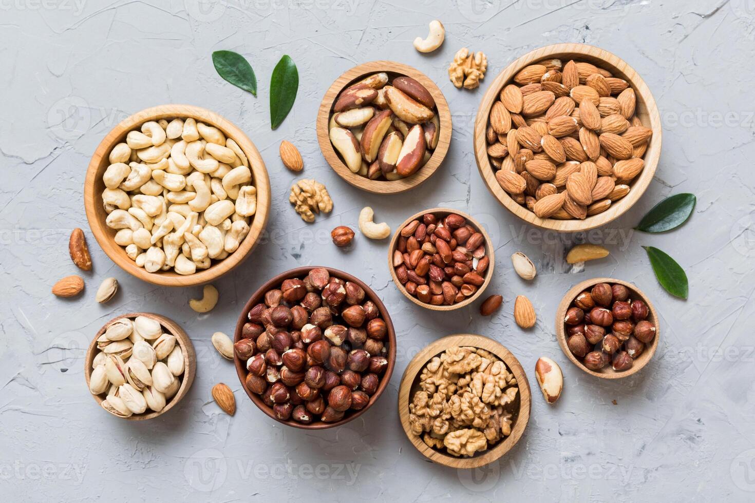 mixed nuts in wooden bowl. Mix of various nuts on colored background. pistachios, cashews, peanuts and brazil nuts photo