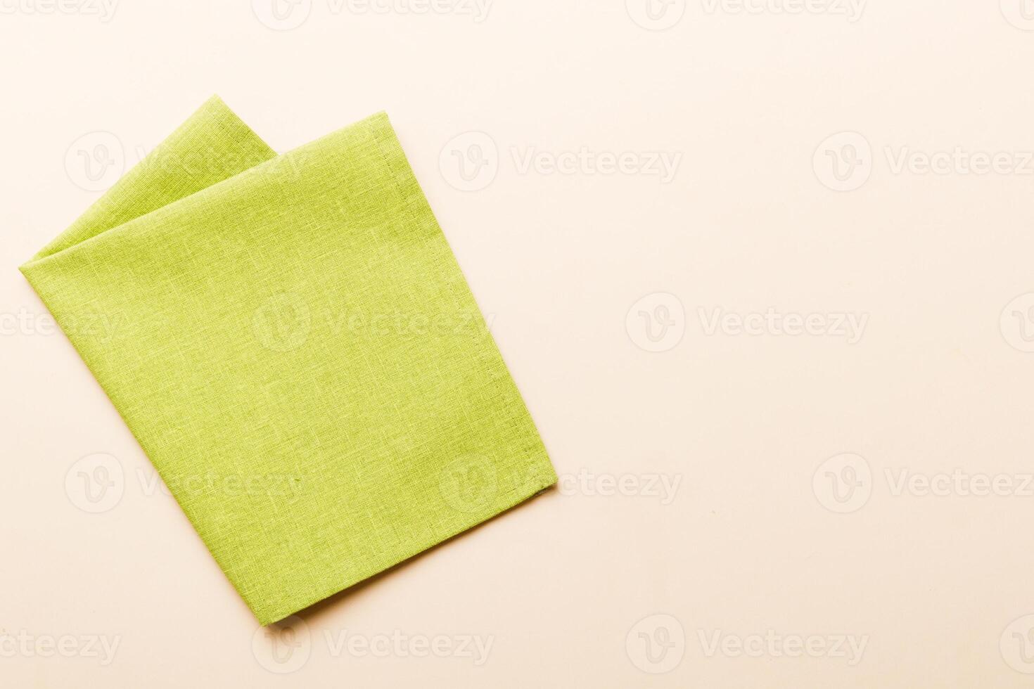 top view with green kitchen napkin isolated on table background. photo