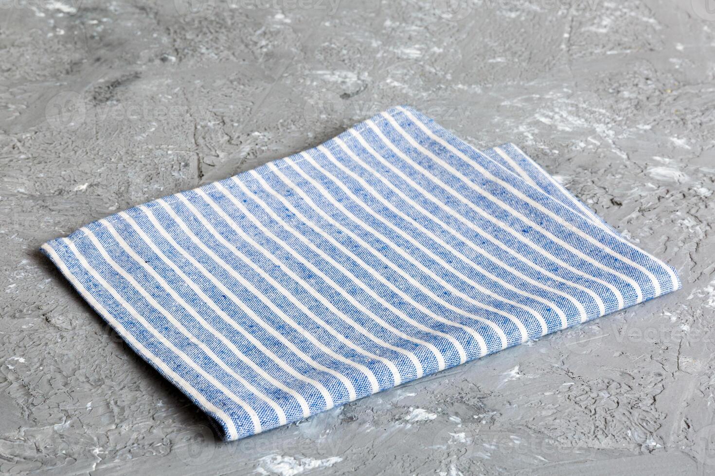 top view with blue kitchen napkin isolated on table Folded cloth for mockup photo