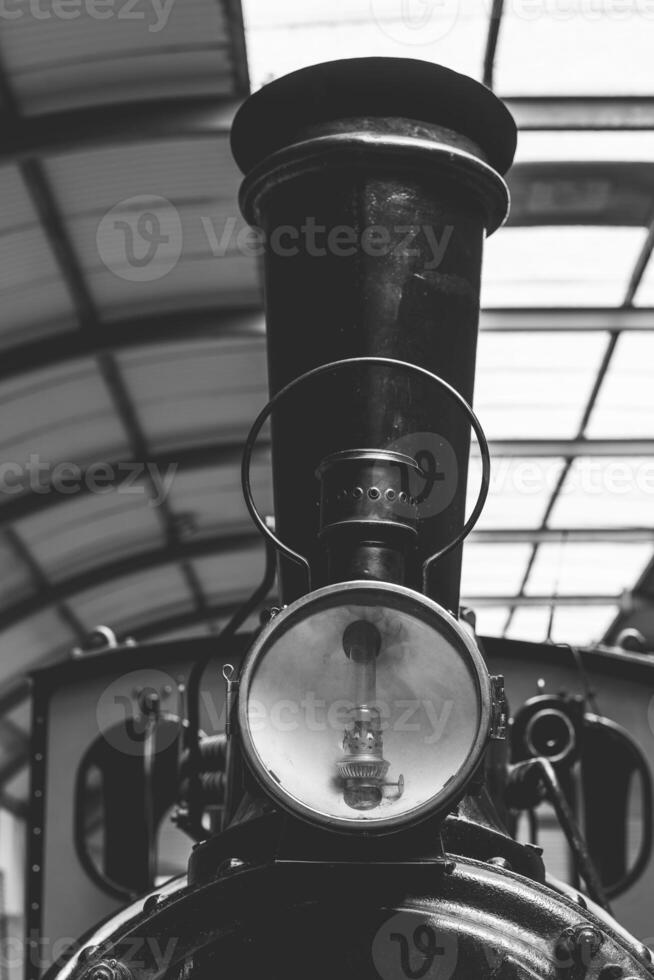Historic steam locomotive with intricate details standing proudly in a vintage railway museum during a sunny afternoon photo