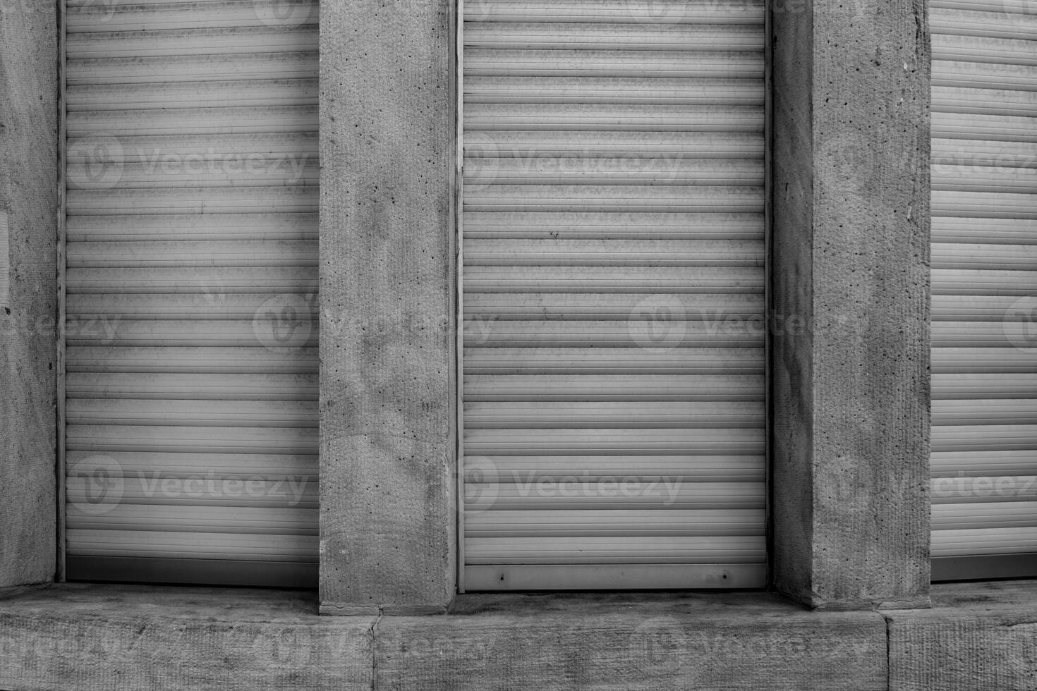 Shuttered windows reveal the texture and patterns of a building in an urban setting during the afternoon photo