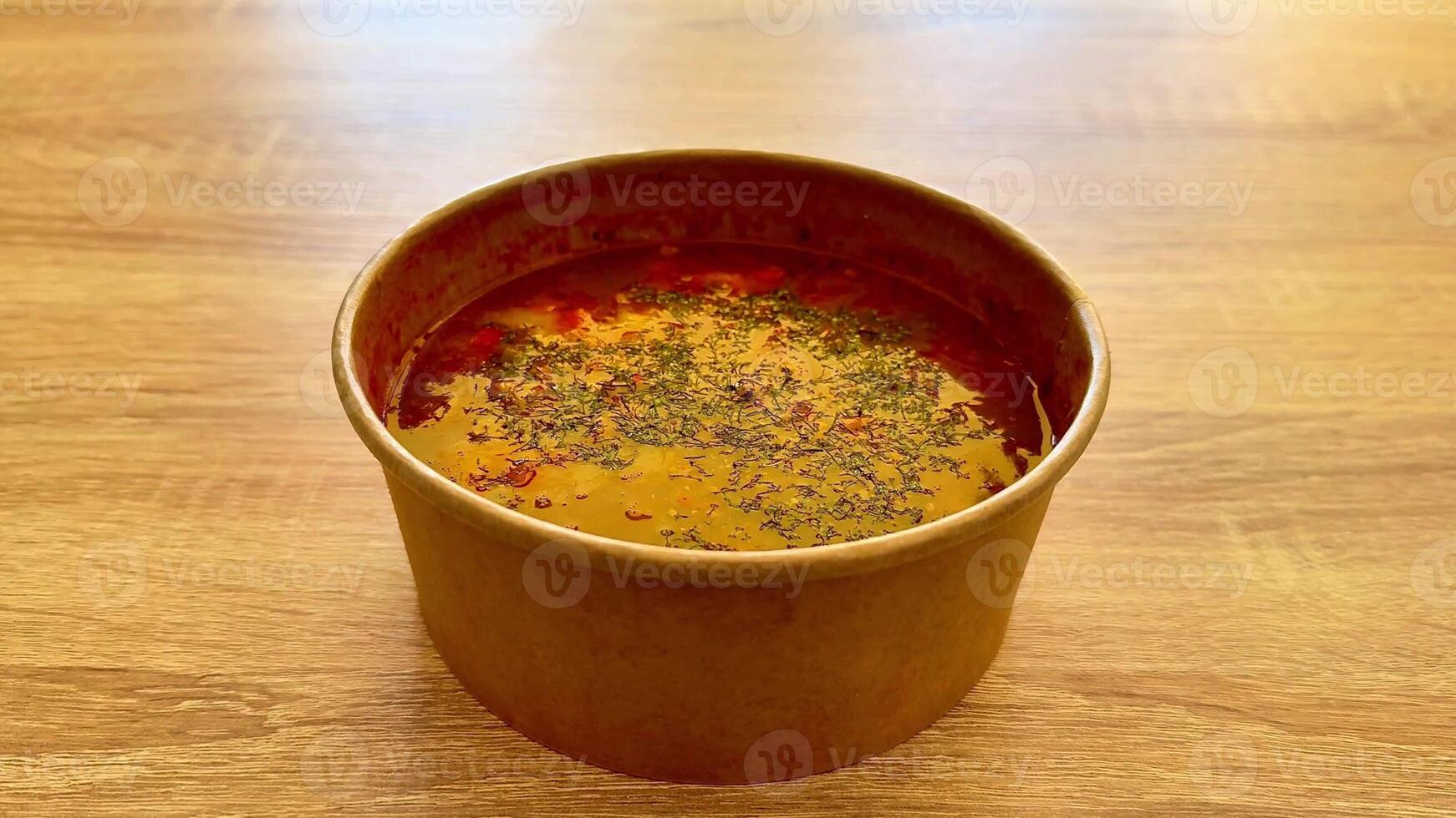 A vibrant and colorful bowl of aromatic spiced soup, meticulously garnished beautifully for an appealing presentation photo