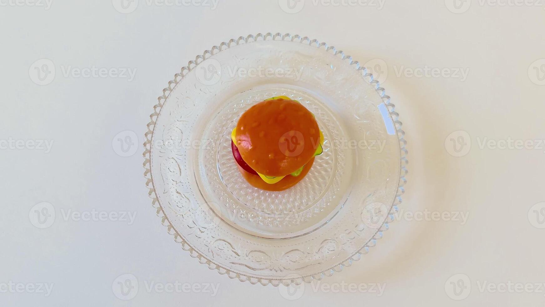 A deliciously scrumptious mini burger beautifully served on a decorative glass plate, ideal for gourmet presentations photo