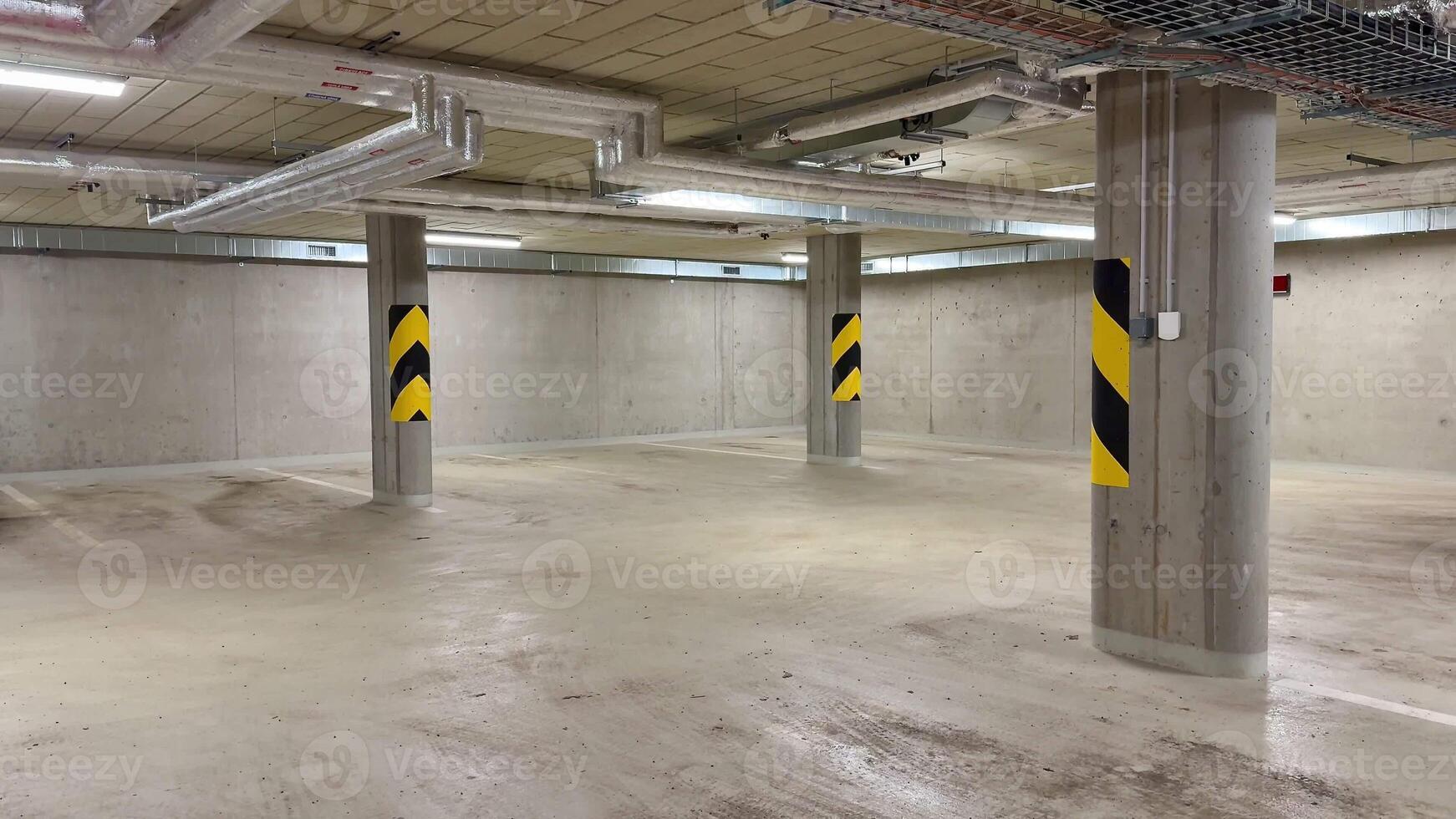 A spacious parking garage with impressive design features and essential safety markings on the pillars photo