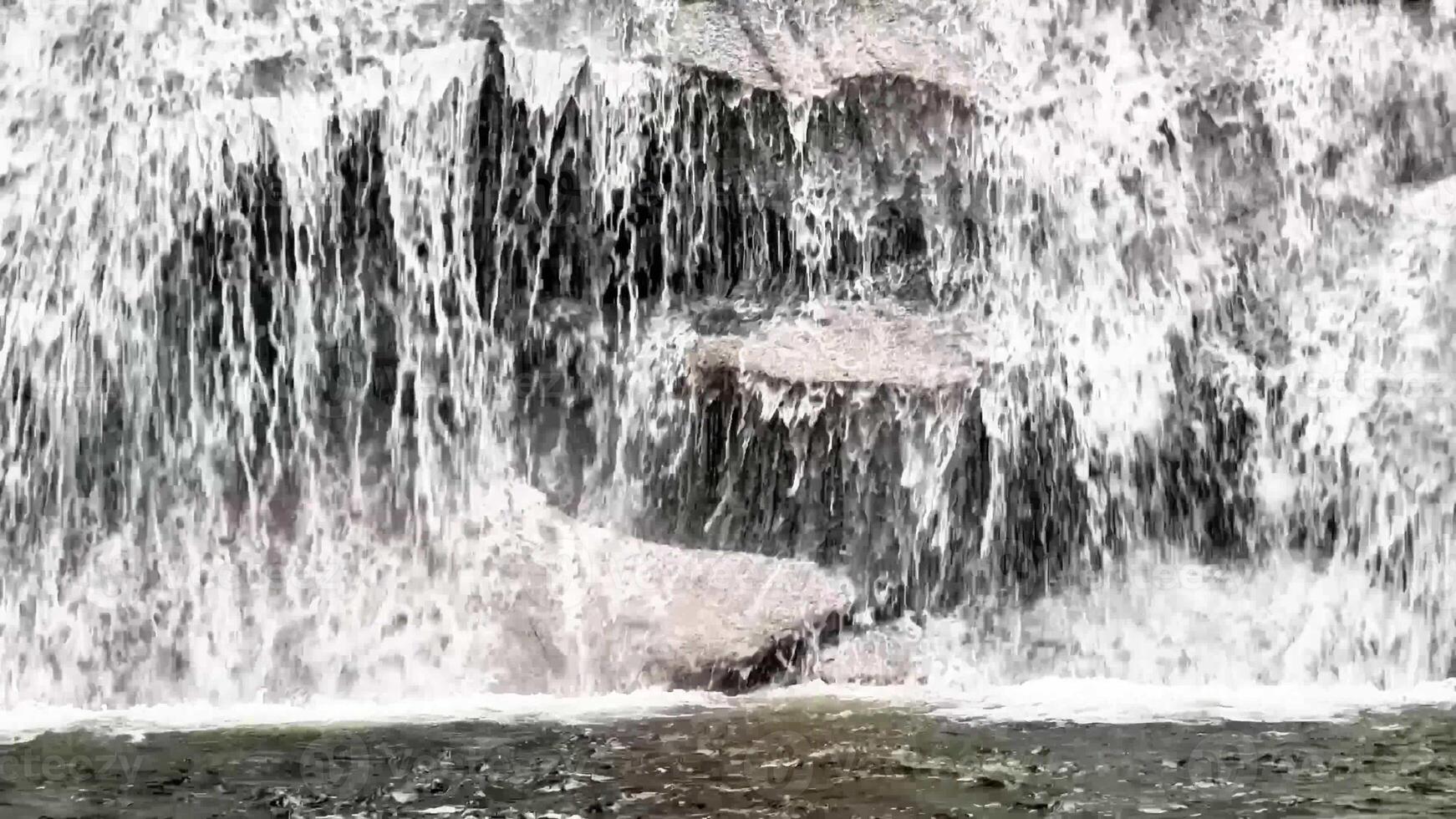 A breathtaking view of a majestic waterfall cascading over rugged rocks a serene natural scene awaits you photo