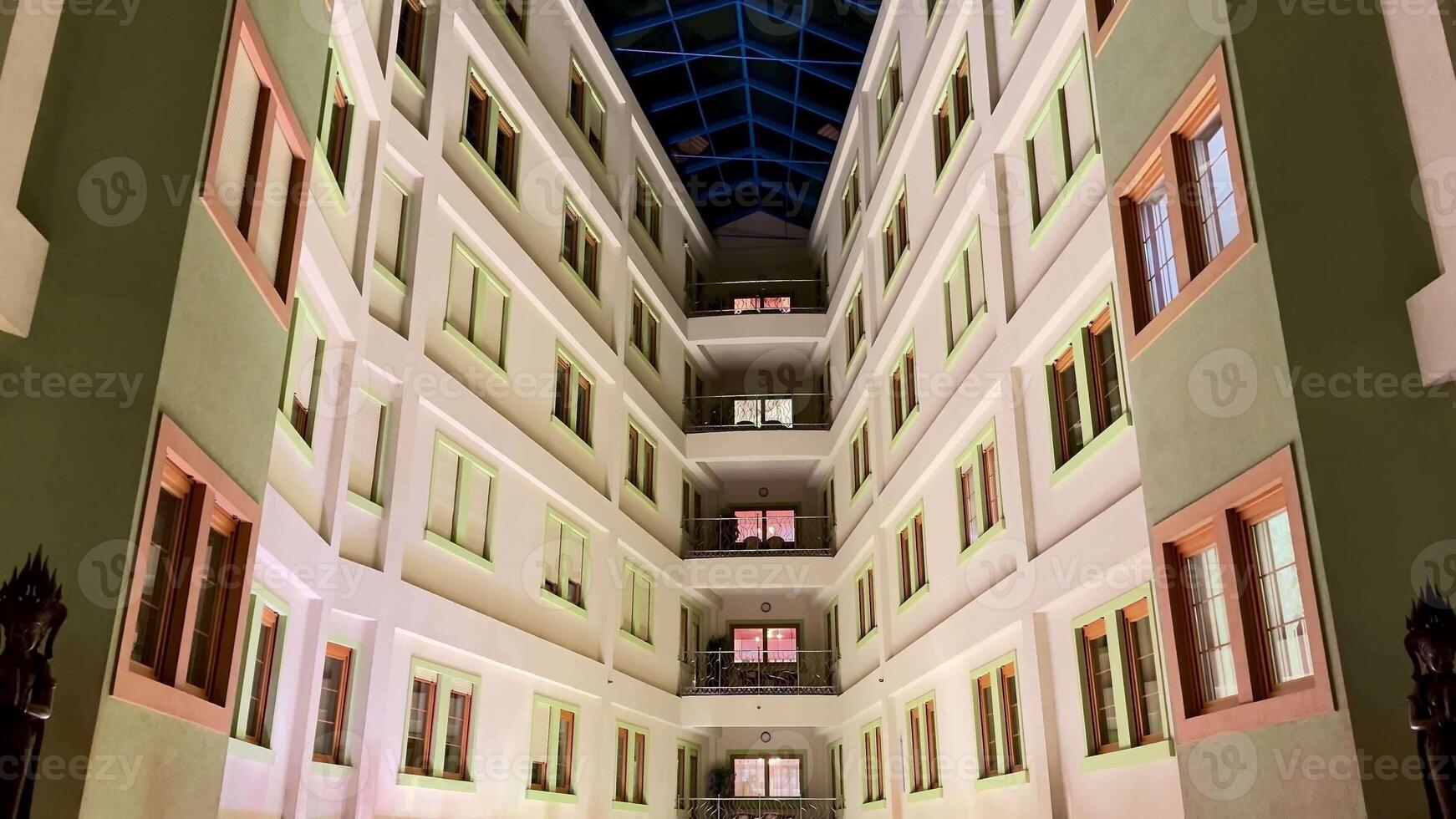 Captivating sight of a stunning modern courtyard showcasing beautiful architectural design and a striking glass ceiling photo