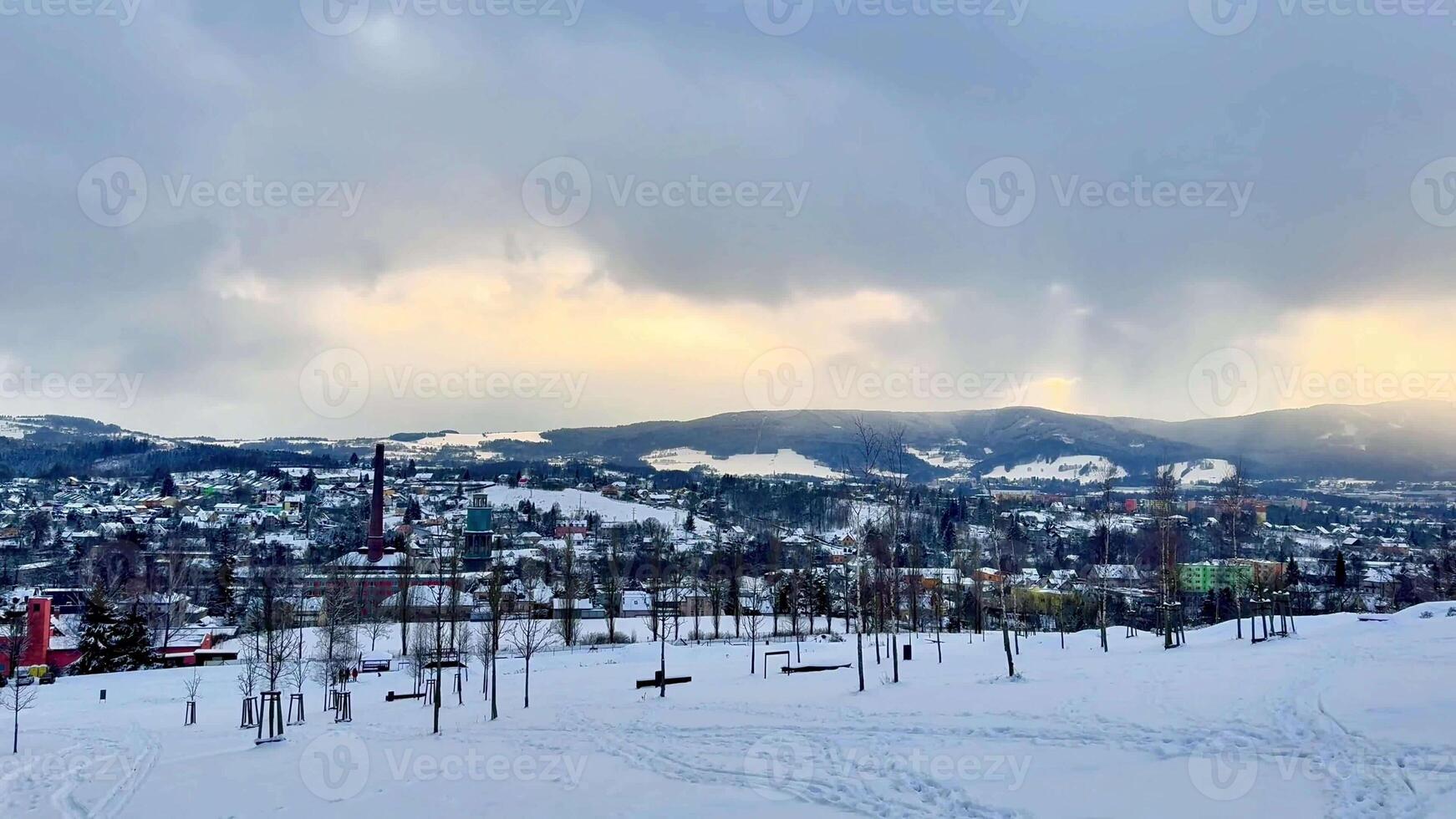 A beautifully scenic winter view showcasing a picturesque snowcovered town that is nestled in the majestic mountains photo