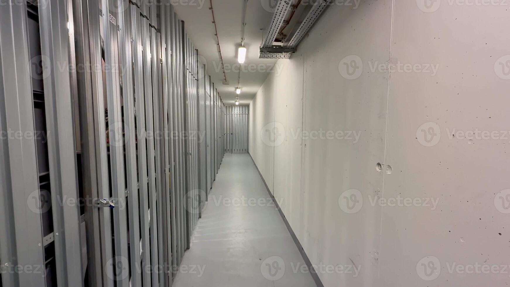 A sleek and minimalistic corridor that is lined with streamlined metal storage units for efficiency and organization photo