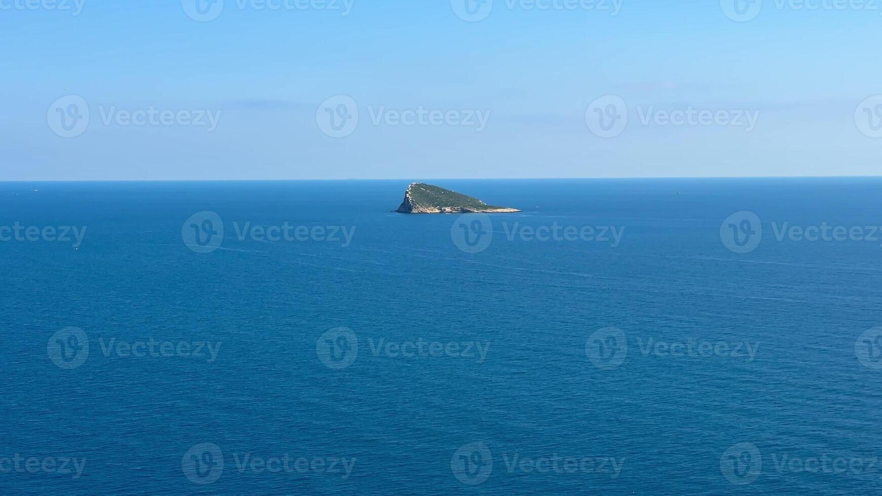 An aerial view beautifully showcases a tranquil ocean gently lapping against a remote island and a vibrant coastline photo