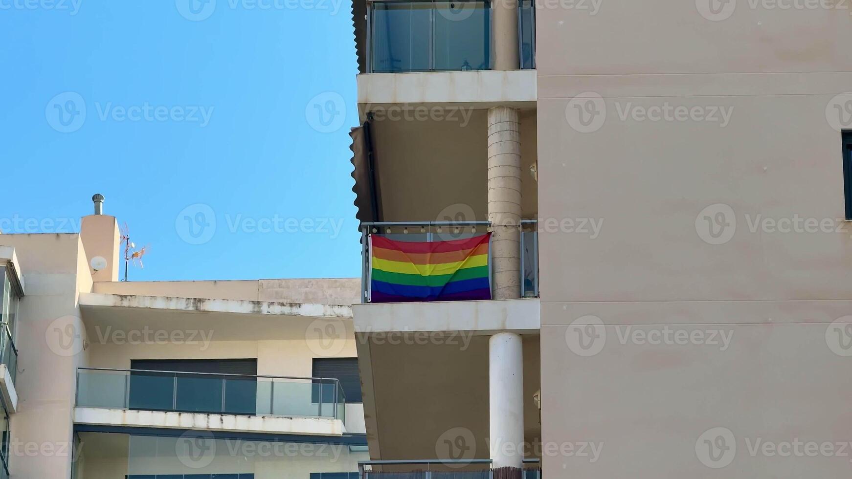 A colorful pride flag on a balcony symbolizes love, acceptance, and inclusivity in our diverse society photo