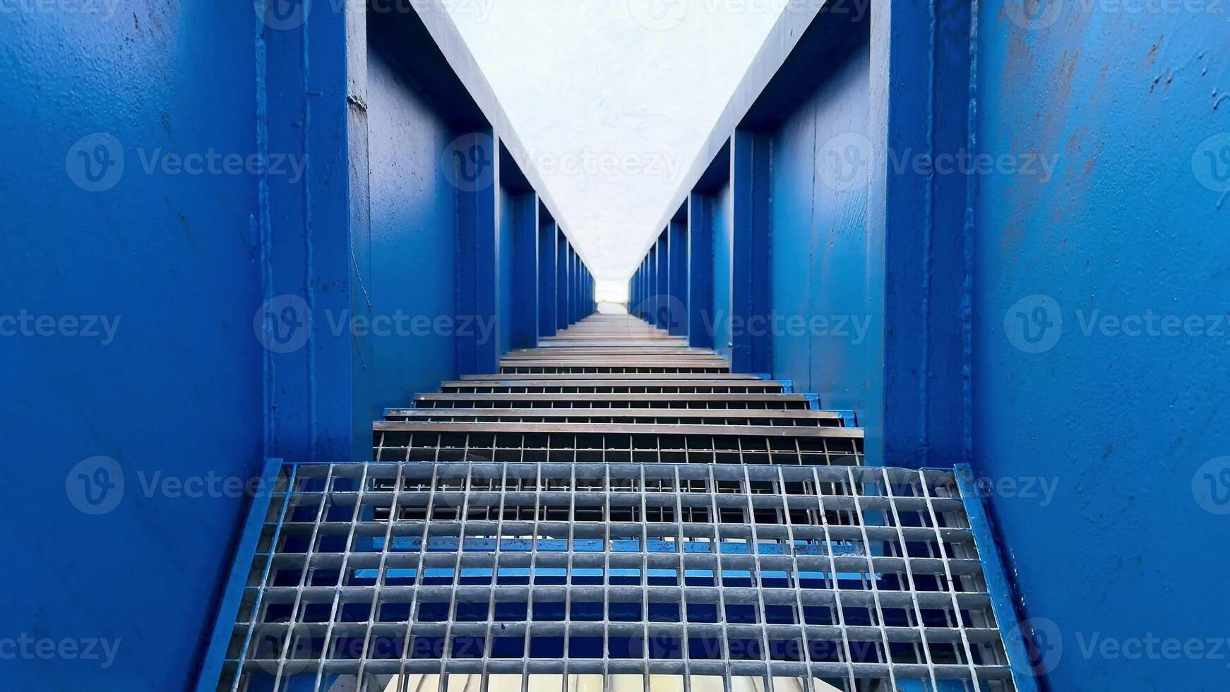 An eyecatching perspective captures a blue structure, showcasing its geometric lines and intricate grid patterns photo