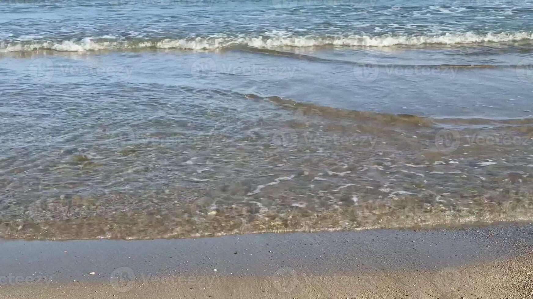 The beautiful ocean waves are gently caressing the soft sandy beach, creating a perfectly tranquil coastal scene photo