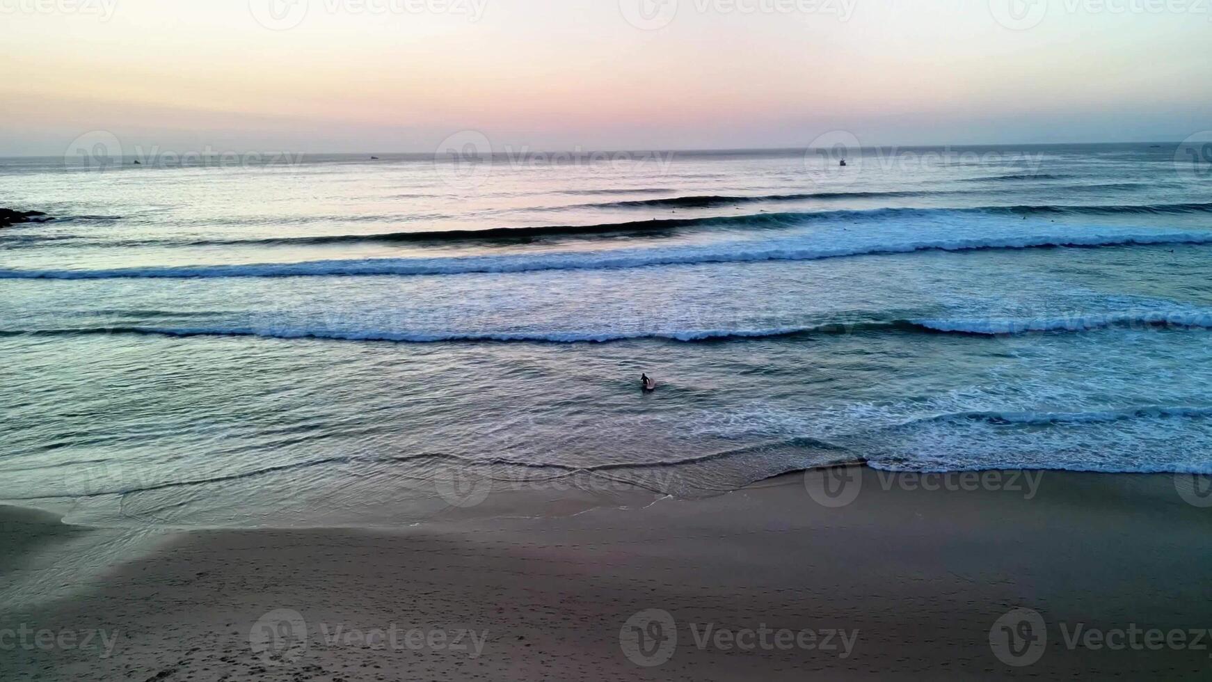 A stunning and picturesque sunset view over the gentle beach waves, creating a serene and calming atmosphere photo