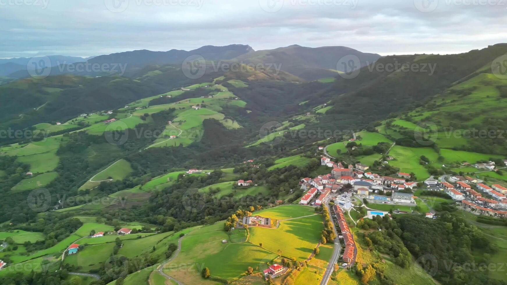 A stunning drone shot showcasing vibrant landscapes and charming hamlets nestled in majestic mountains photo
