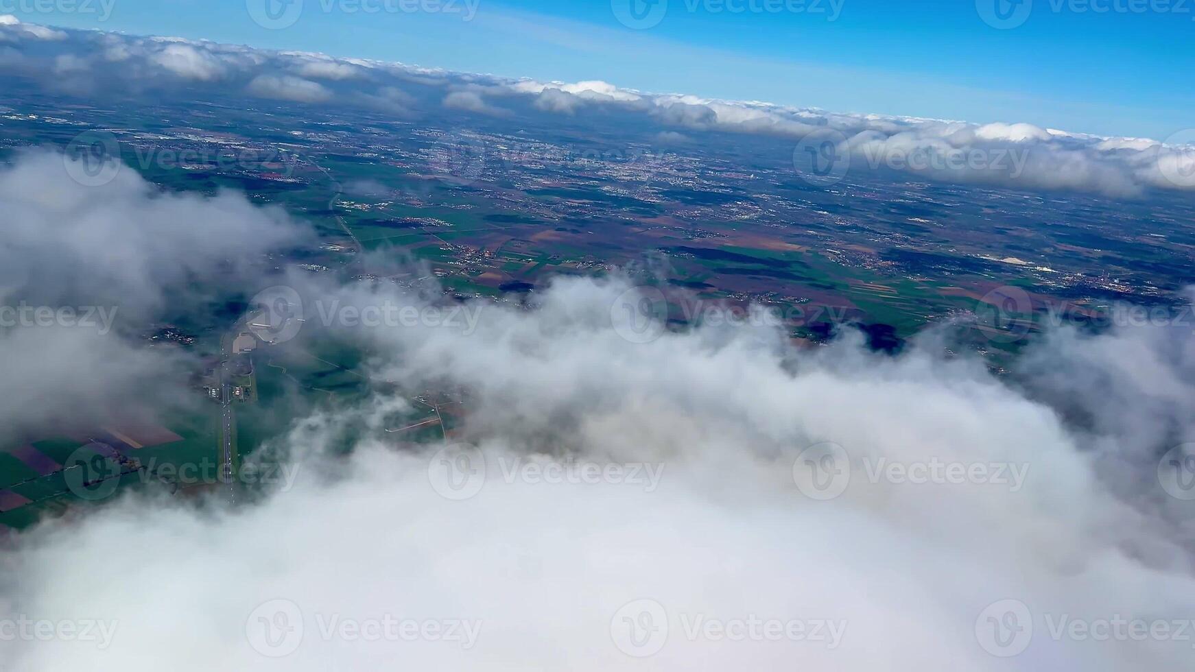 This breathtaking aerial footage showcases stunningly vibrant fields accompanied by wispy clouds drifting above photo