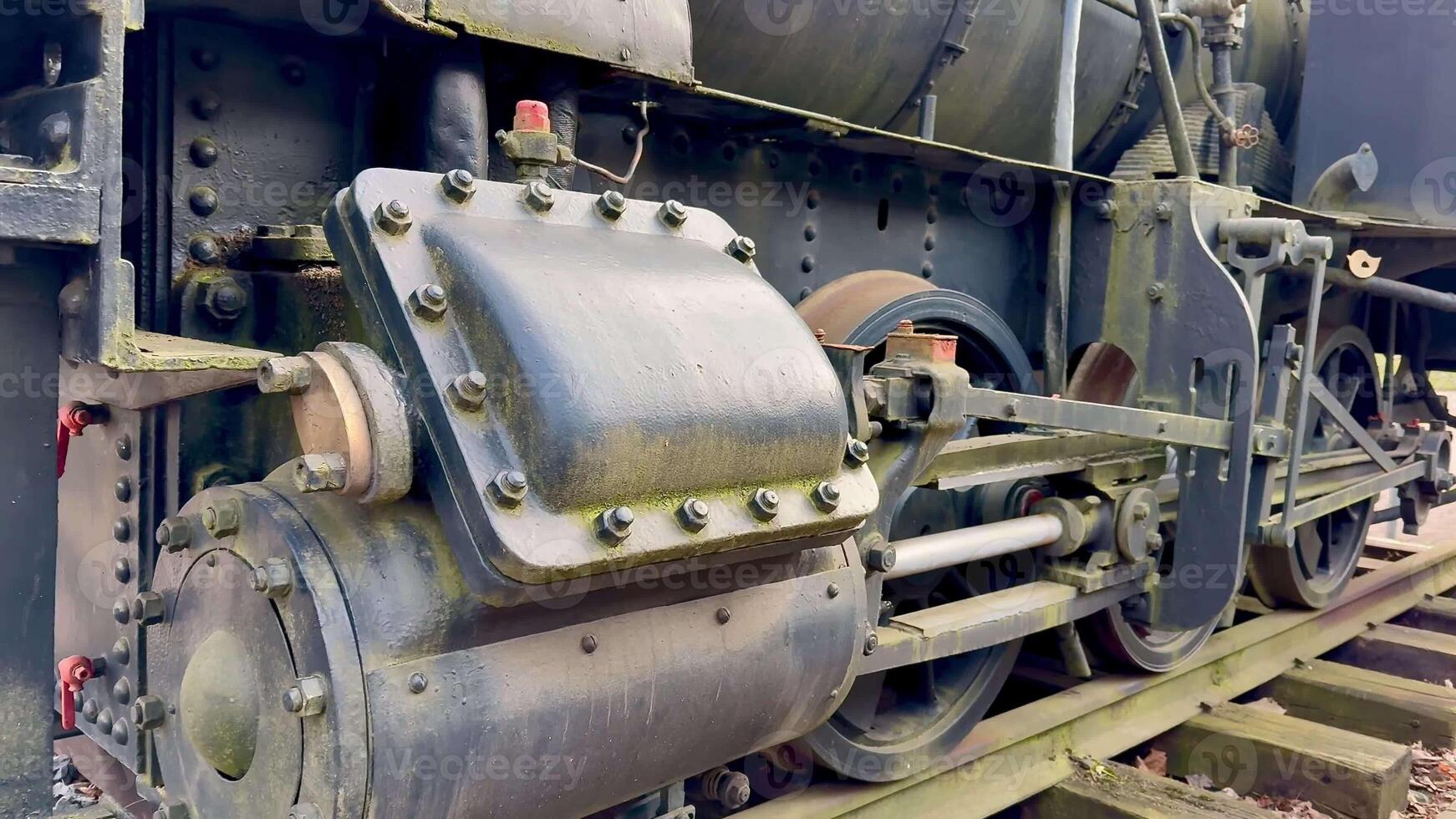 This is a closeup detailed view of a vintage steam locomotives intricate engine components and machinery systems photo