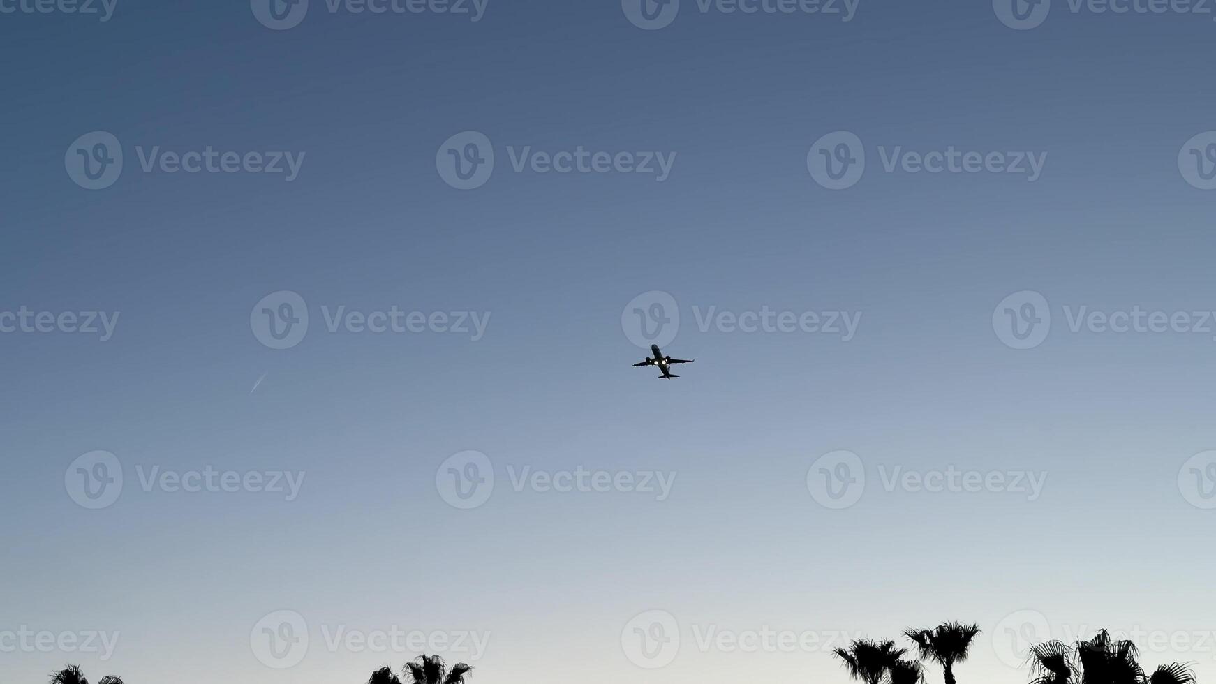 An airplane skillfully navigates the bright blue sky, showcasing the wonders of modern aviation technology photo
