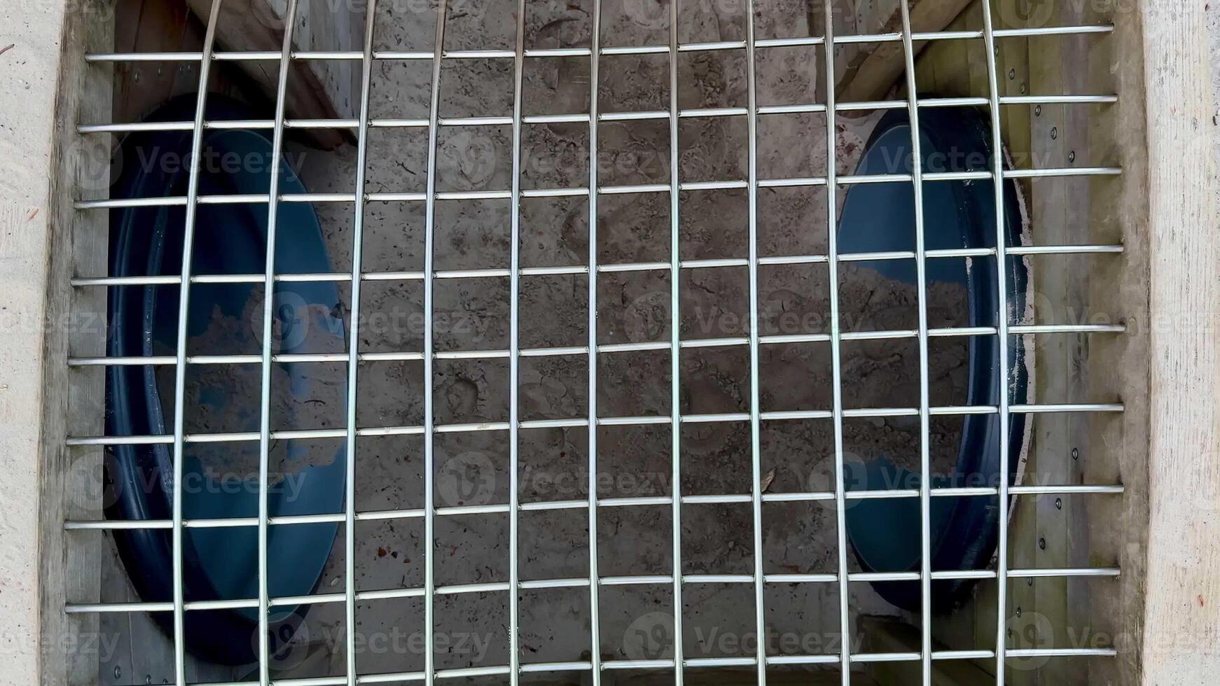 This image shows a closeup of a drainage grate with blue inlets for efficient water flow management photo