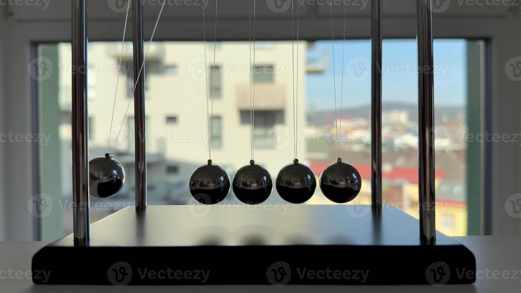 An elegantly crafted depiction of Newtons cradle effectively demonstrating fundamental physics principles photo