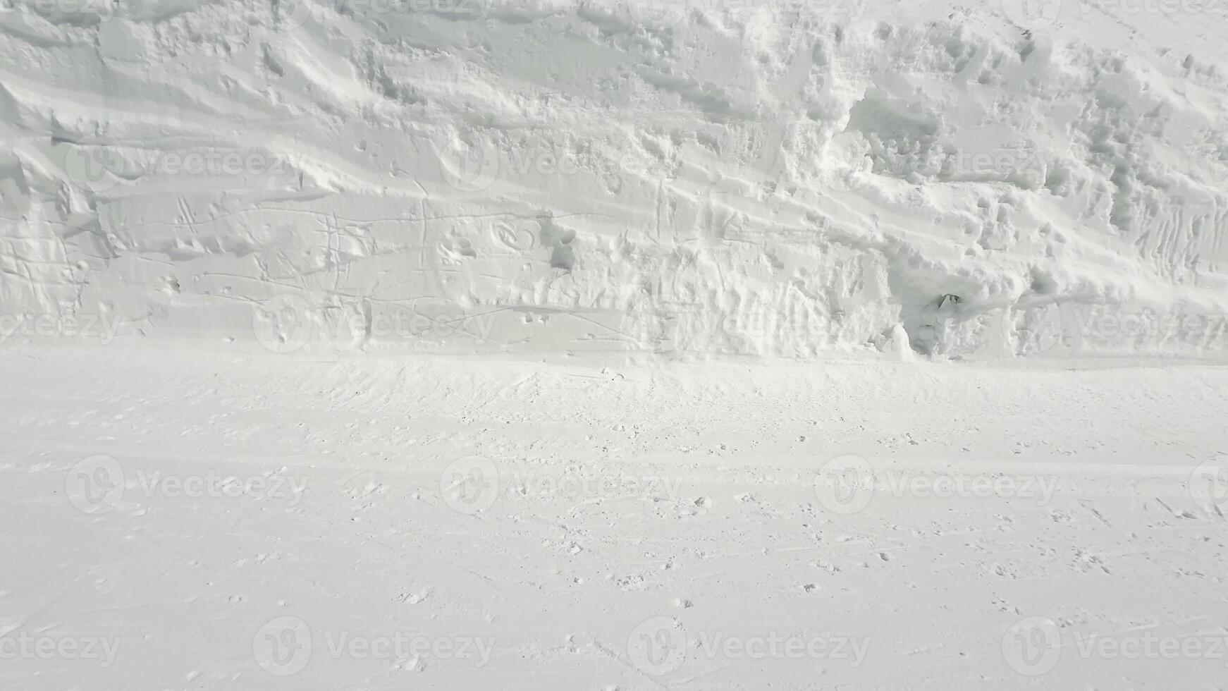 A serene winter scene beautifully showcasing pristine, untouched snow that covers the ground and the hillside photo