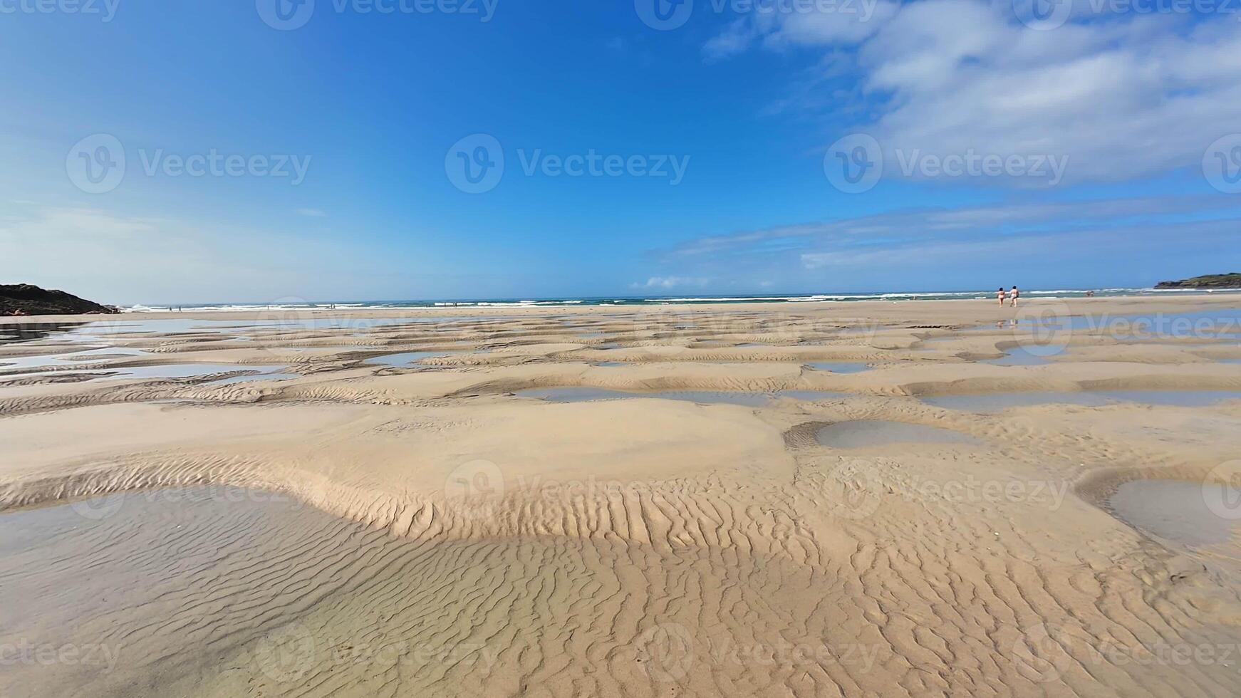 A stunning sandy beach with beautiful tidal patterns, ideal for nature lovers and vacation getaways photo