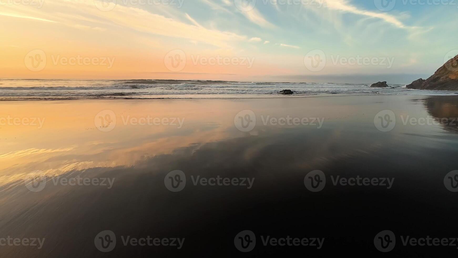 A breathtaking beach sunset that reflects beautifully on the calm waters, creating a truly peaceful atmosphere photo