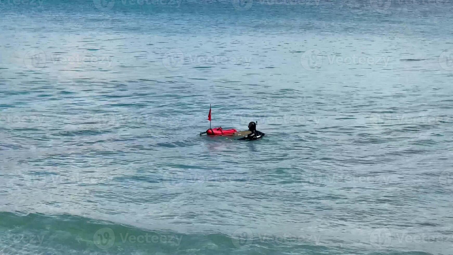 A skilled diver explores vibrant ocean depths with a safety buoy, showcasing a thrilling underwater adventure photo