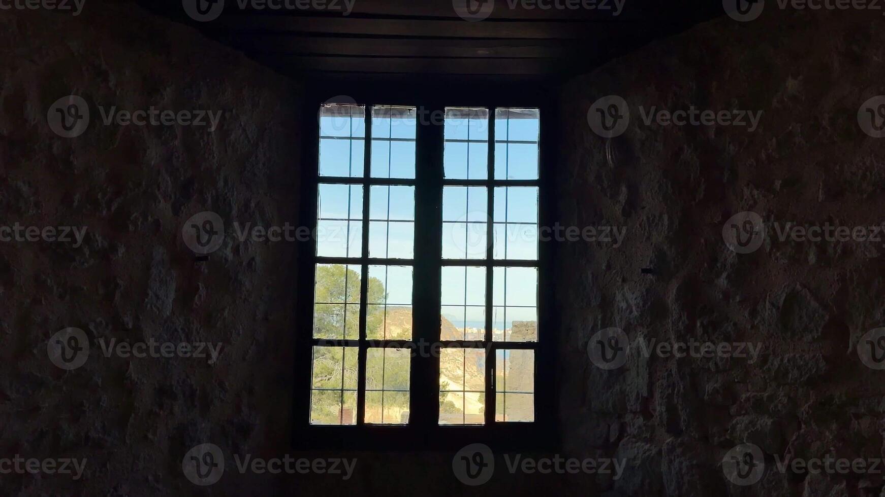 A picturesque view through charming, rustic stone window frames, beautifully showcasing the splendor of nature photo