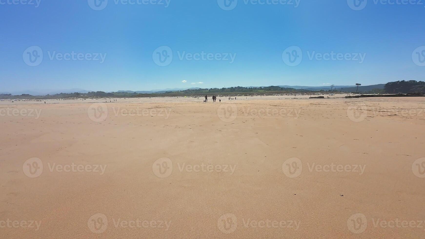 A tranquil beach with soft golden sands, gentle waves, and a clear blue sky, perfect for relaxation photo