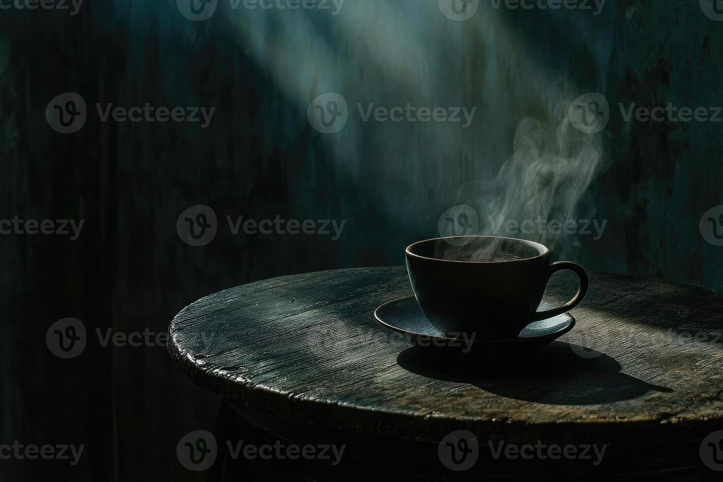 A cup of coffee sits on a table in front of a blue wall photo