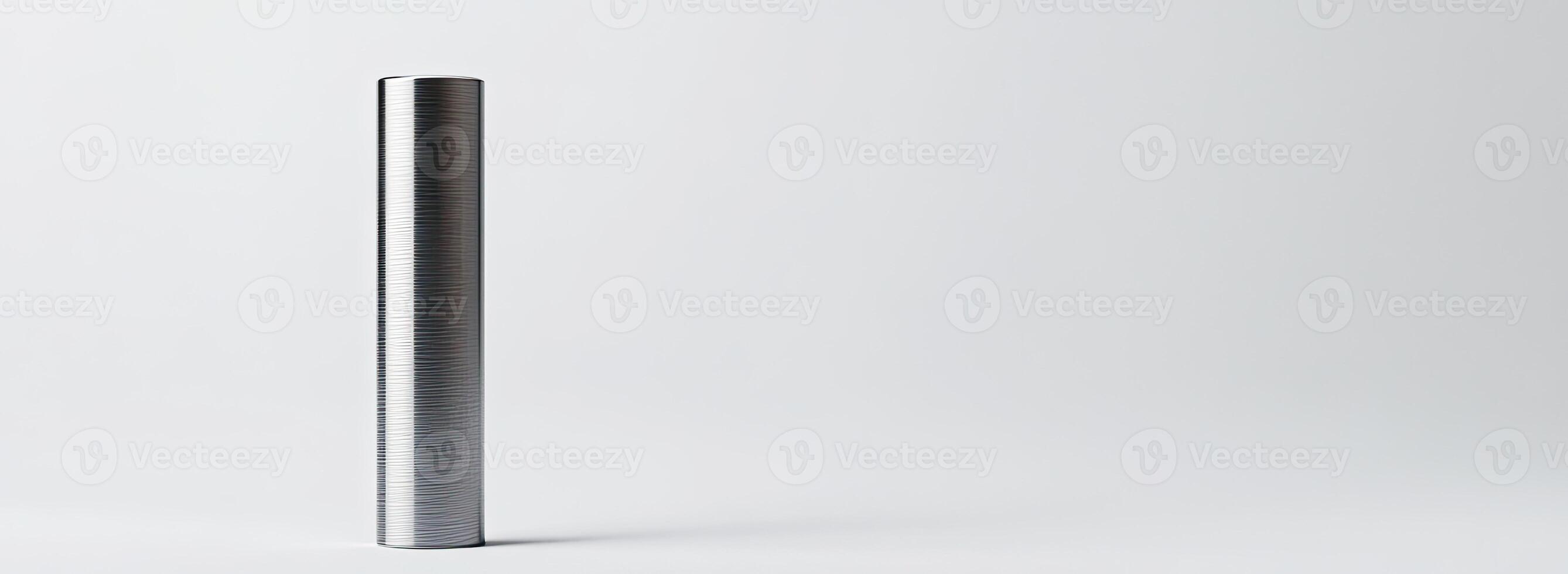 A vertical metallic cylinder stands on a white background photo