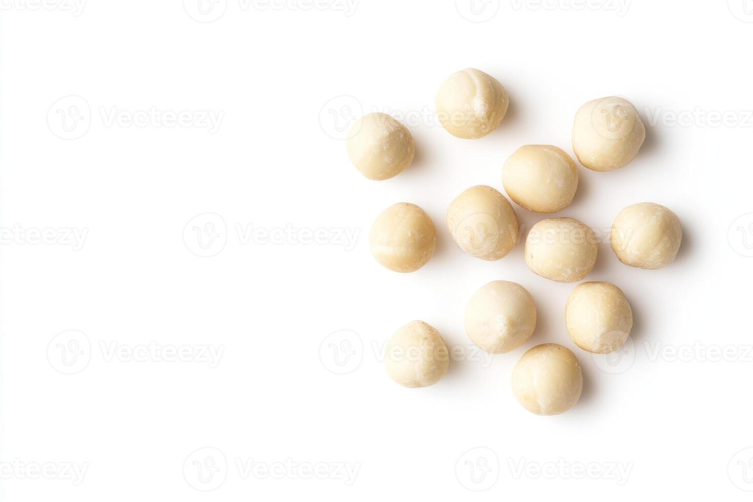 Scattered Macadamia Nuts Isolated On White Background photo
