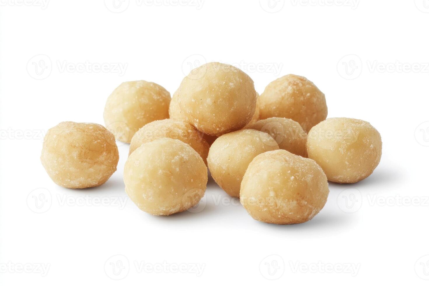 A pile of roasted macadamia nuts sits on a white background photo