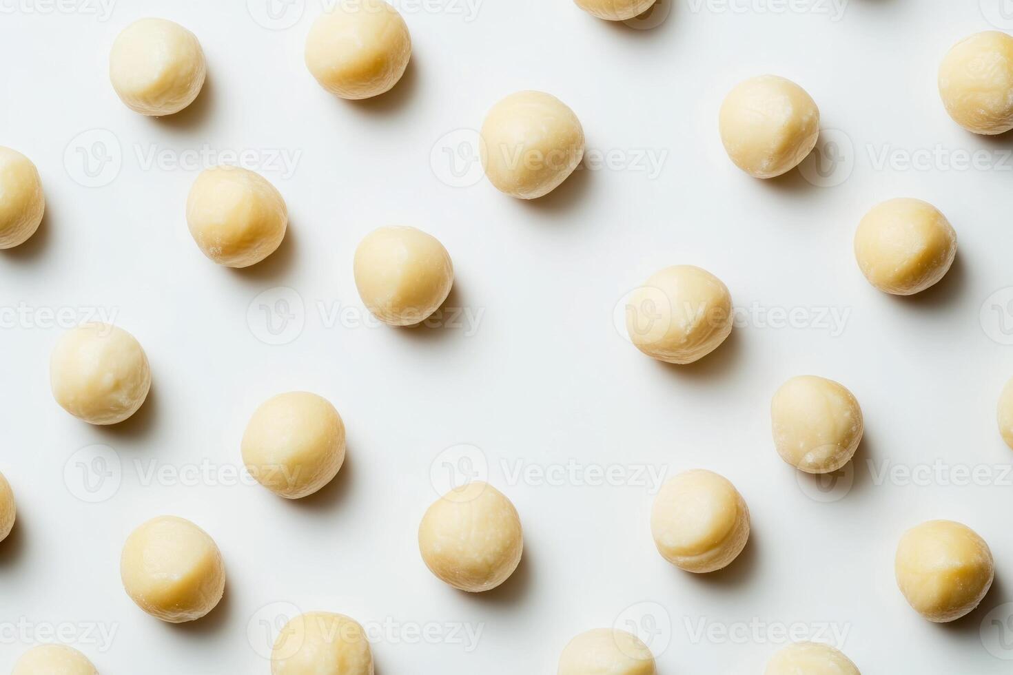 Macadamia nuts arranged in a repeating pattern photo