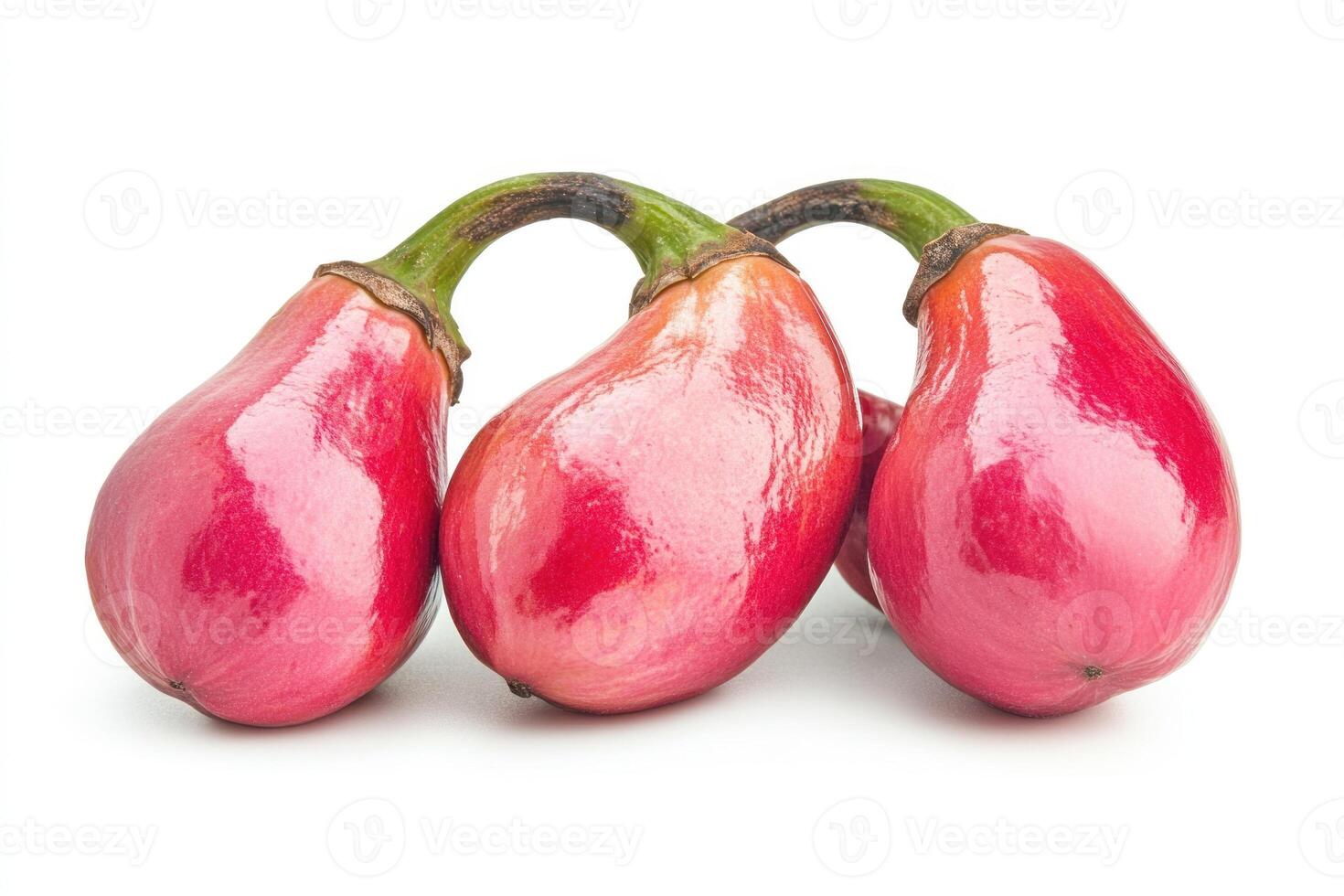 Three ripe red cashew apples clustered together photo