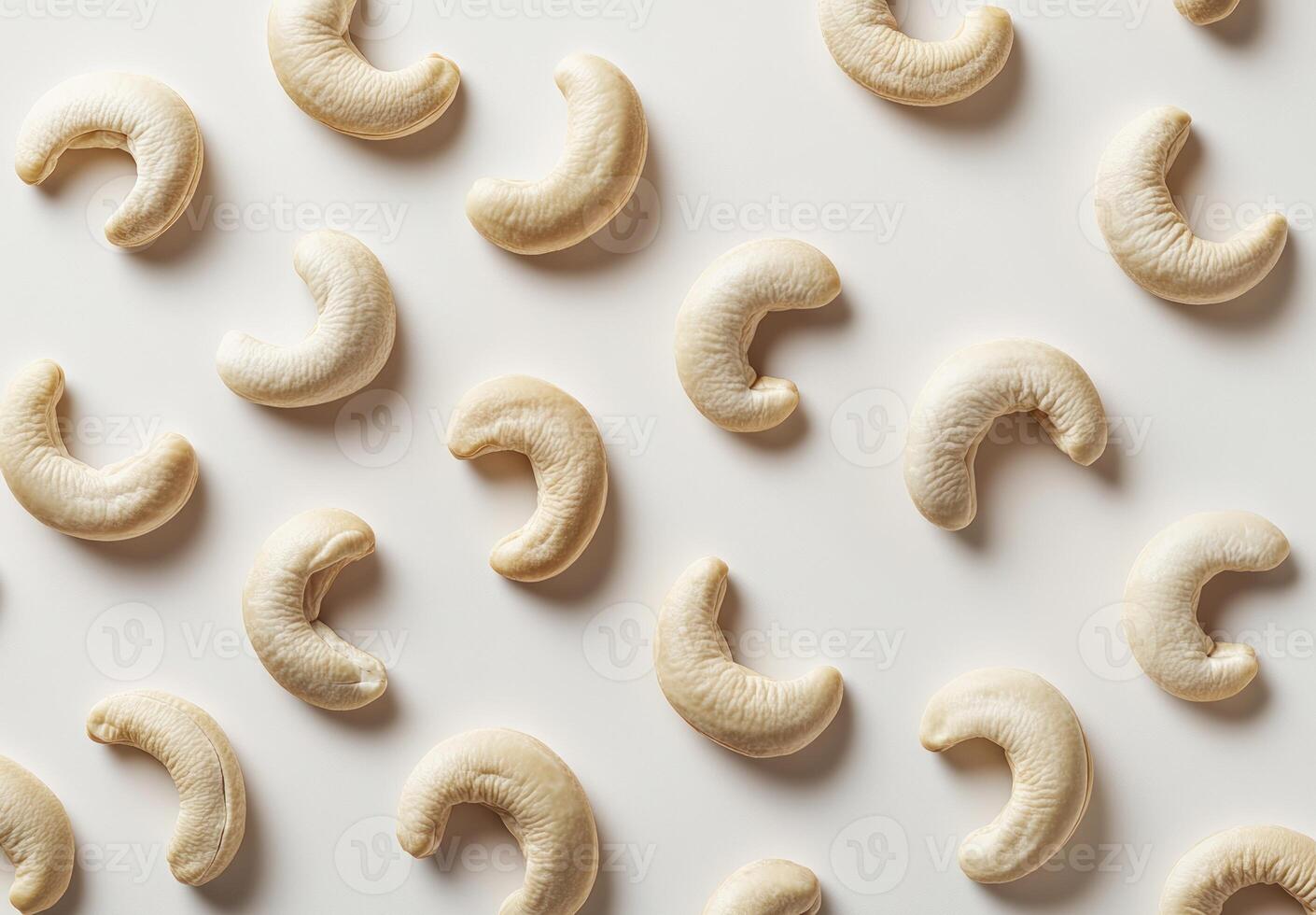 Cashew nuts arranged in a patterned design on a white background photo