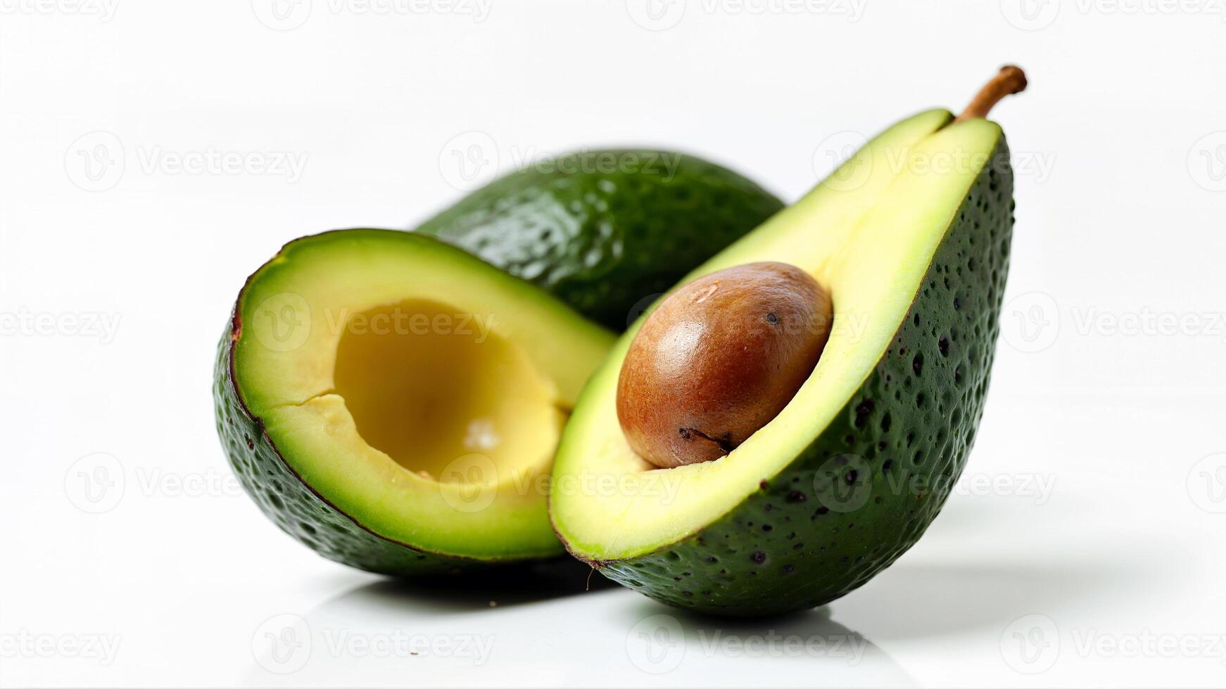 Isolated ripe avocado cut in half with pit and tender flesh on a white background. Useful for food, nutrition, and healthy eating concepts. photo
