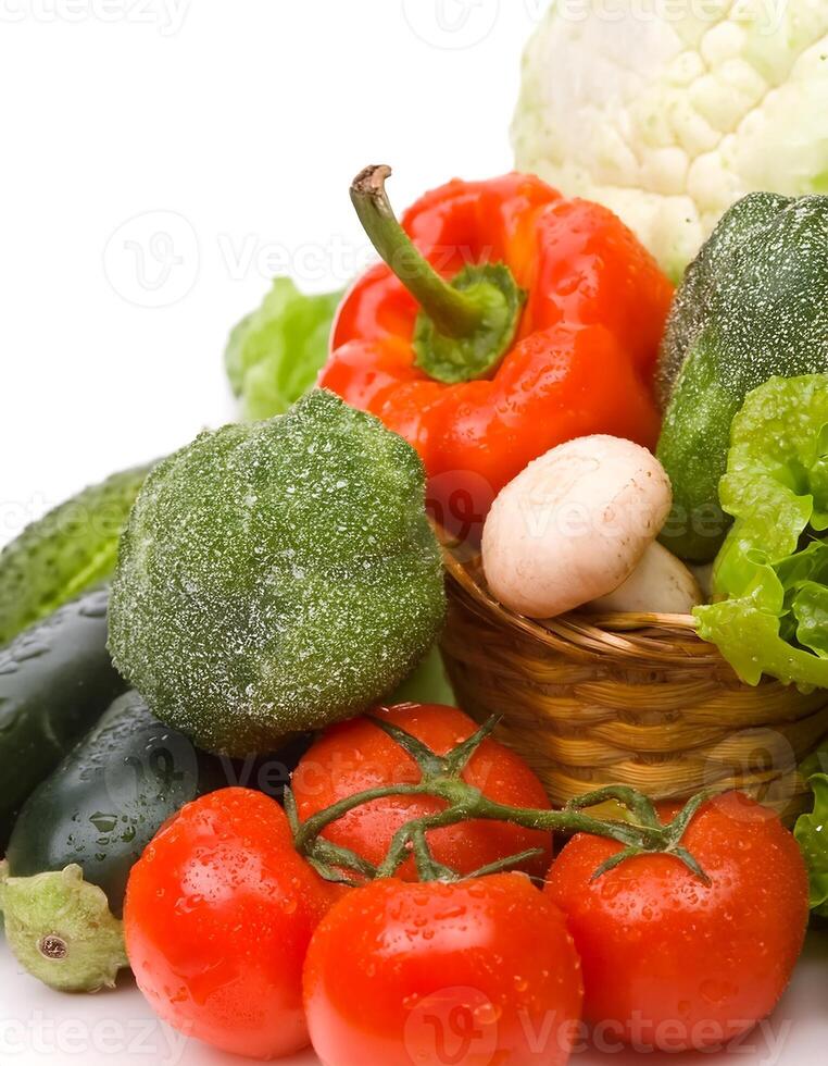 A basket of vegetables with tomatoes, peppers, and cucumbers photo