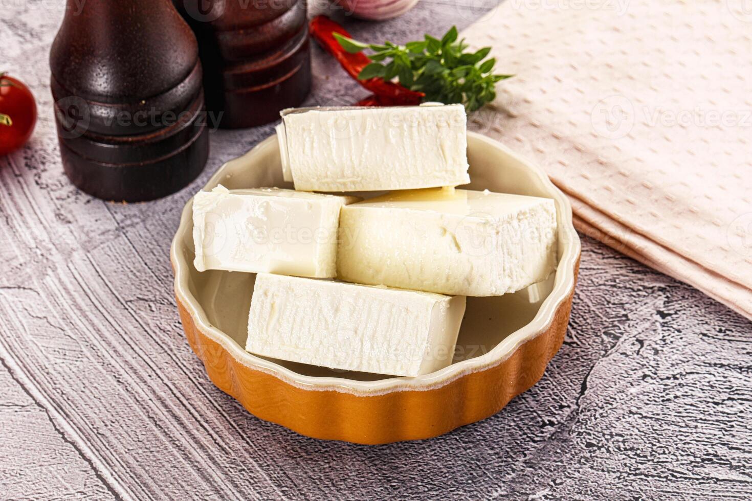 A bowl of butter with a knife and a bottle of beer photo