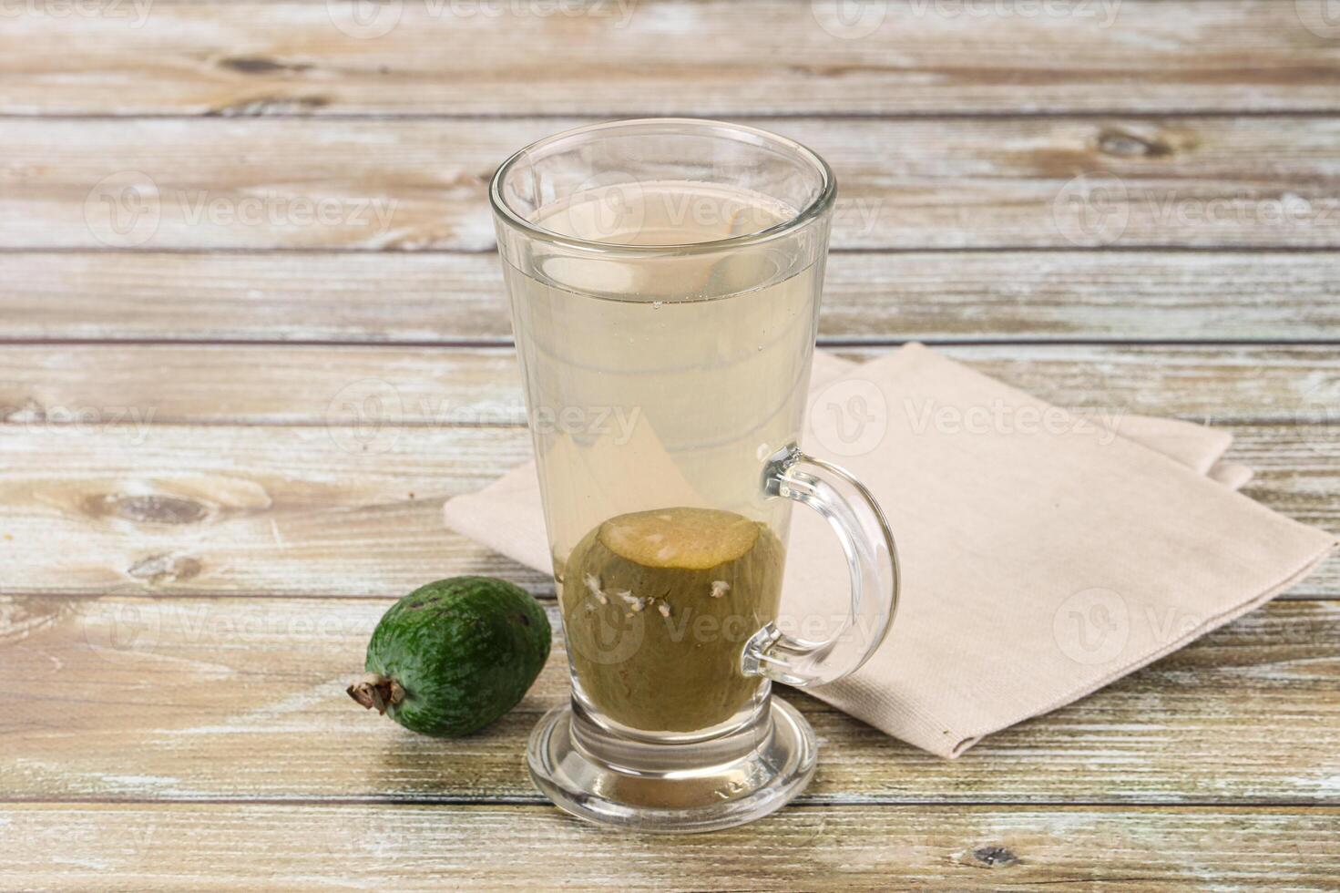 A glass of water with an avocado in it photo