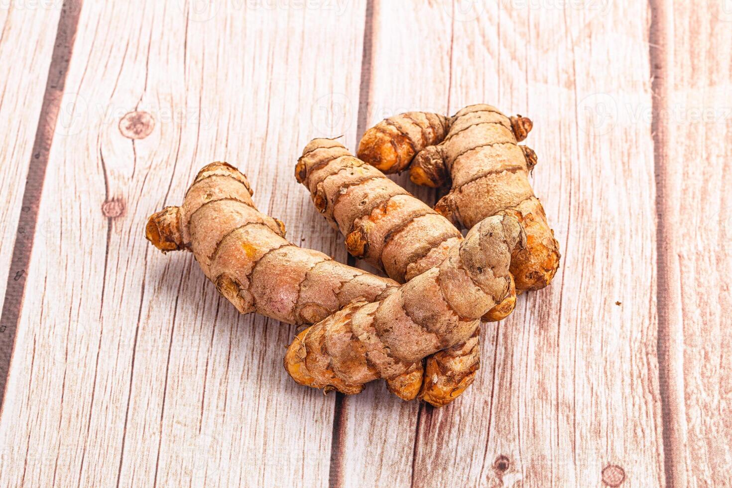 Ginger root on a wooden table photo
