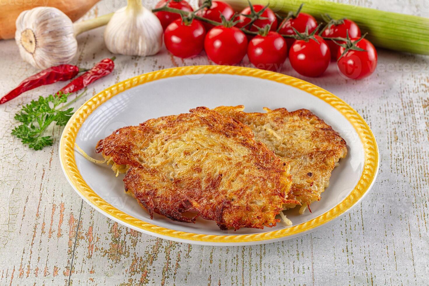 A plate of fried chicken with vegetables and herbs photo
