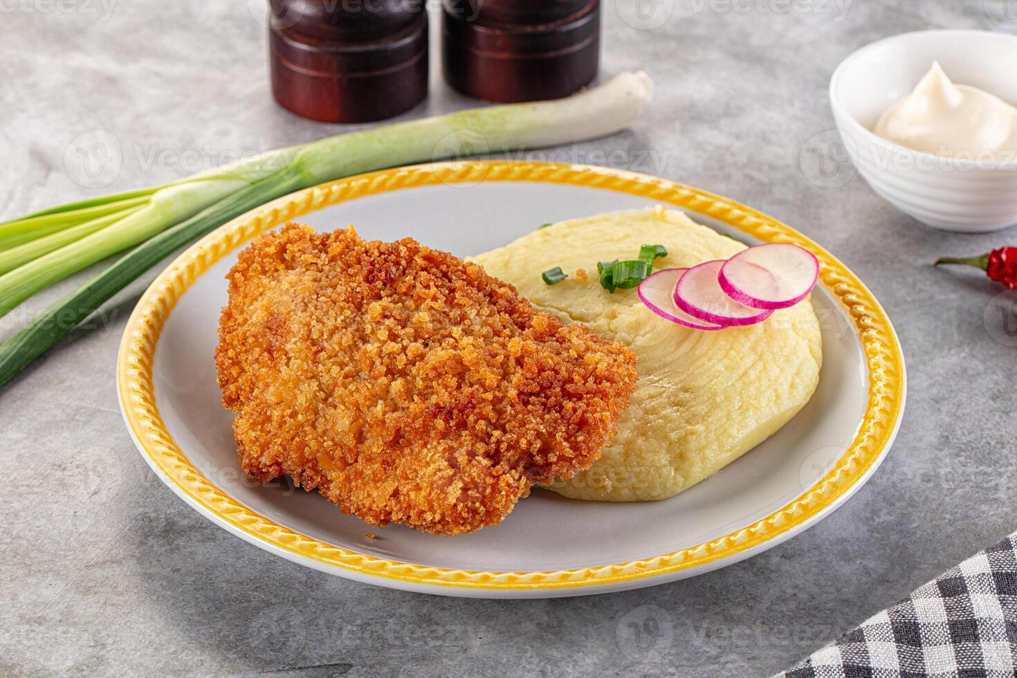 A plate with fried chicken and mashed potatoes photo