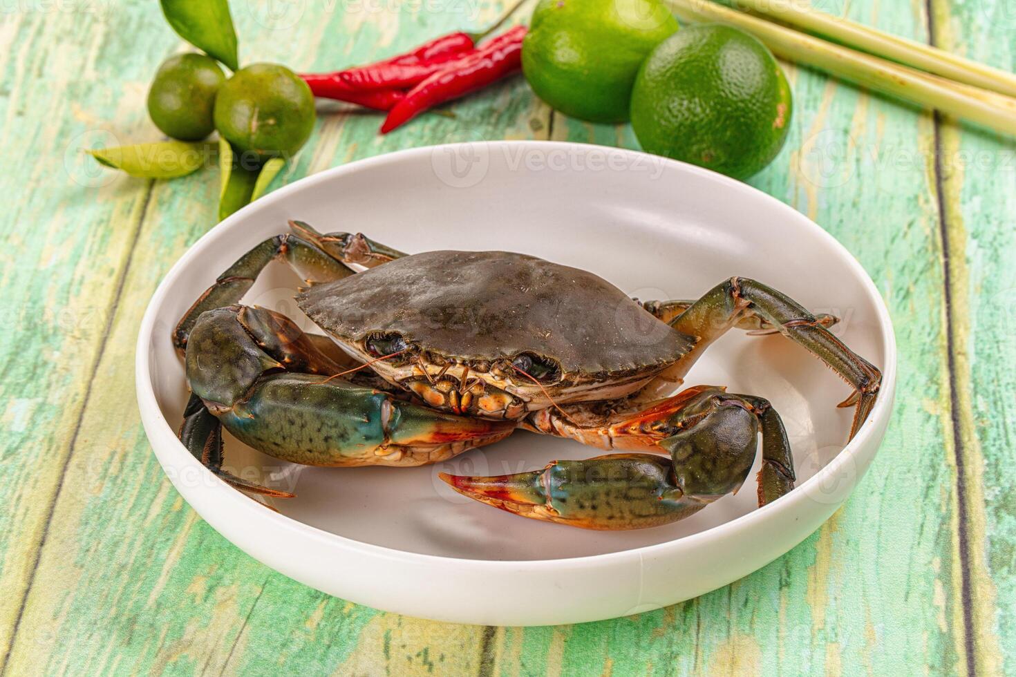 A crab sitting in a bowl on a table photo