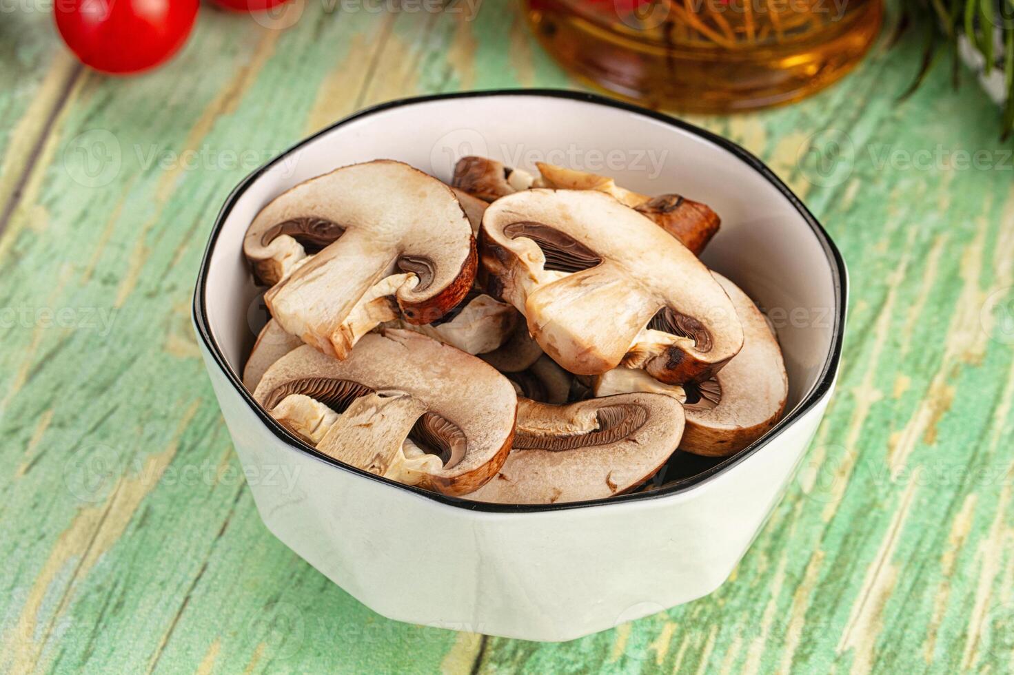 A bowl filled with mushrooms on a table photo